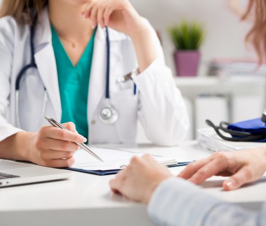 Doctor consulting patient hands closeup. Patient sitting at doctor office. Diagnostic prevention of women diseases healthcare medical service consultation or education healthy lifestyle concept